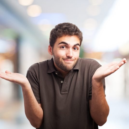 portrait of handsome young man doing a doubt gesture