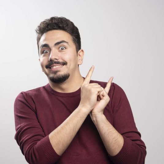 A happy brunette man posing with his hands . High quality photo